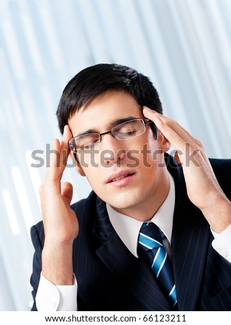 Thinking, tired or ill with headache businessman at office