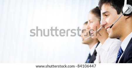 Three happy customer support phone operators at office Three happy customer support phone operators at office