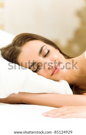 Young happy beautiful woman sleeping at home