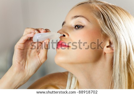 Young woman dripping nose at home