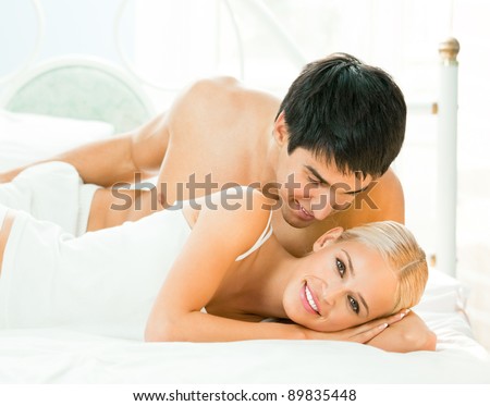 Young beautiful couple making love in bed