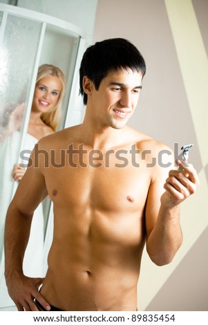 Shaving man and young woman at bathroom