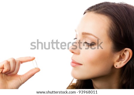 Portrait of young happy smiling woman showing Omega 3 fish oil capsule, isolated over white background