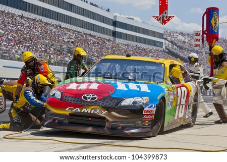DOVER, DE - JUN 03:  Kyle Busch (18) brings in his MMs Toyota for service during the FedEx 400 Benefiting Autism Speaks at the Dover International Speedway in Dover, DE.