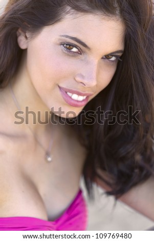 A brunette model posing in a desert environment