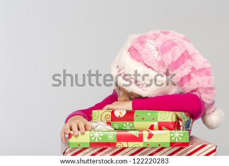 Young girl with missing teeth shows excitement with presents
