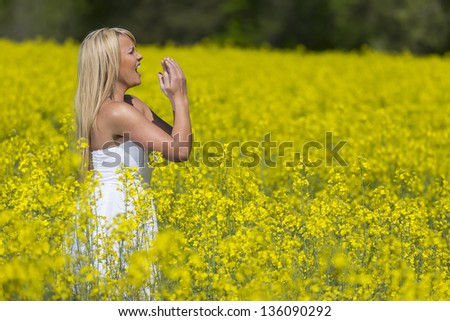 A blonde model in a field of flowers with allergies