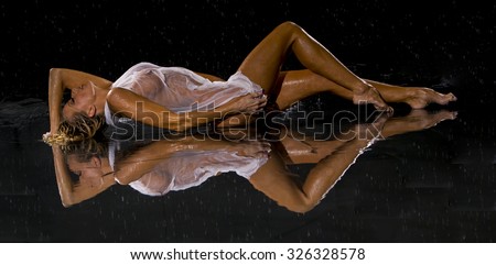 Model posing against a studio rain curtain