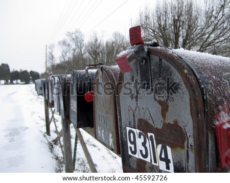 A row of mailboxes covered in snow from a late winter storm