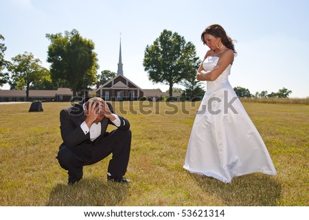 A married couple stand in front of the church, trying to make their decision