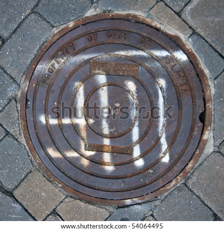Atlanta rustic manhole cover storm drain in concrete