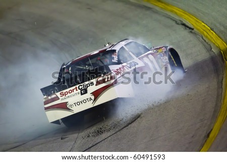 HAMPTON, GA - SEP 05:  Denny Hamlin\'s Sport Clips Toyota spins off turn 1 after blowing up during the Emory Healthcare 500 race at the Atlanta Motor Speedway in Hampton, GA on Sep 05, 2010.