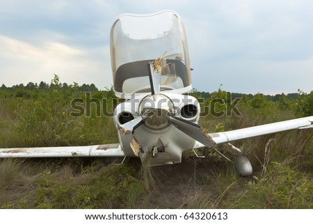 Small general aviation aircraft crash lands in a field