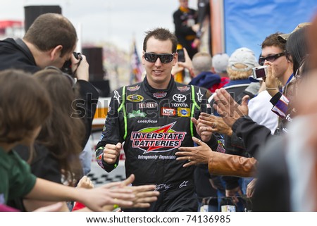 FONTANA, CA - MAR 27: Kyle Busch (18) walks through the line of fans before the start of the Auto Club 400 NASCAR Sprint Cup race at the Auto Club Speedway in Fontana, CA on Mar 27, 2011.