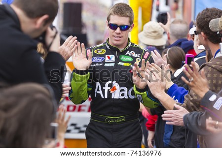 FONTANA, CA - MAR 27: Carl Edwards (99) walks through the line of fans before the start of the Auto Club 400 NASCAR Sprint Cup race at the Auto Club Speedway in Fontana, CA on Mar 27, 2011.