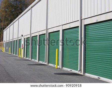 Row of outdoor green door self-storage units