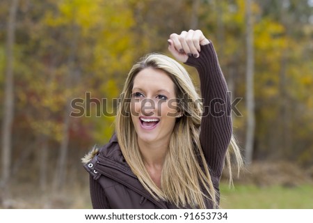 Beautiful woman cheering on her team in an outdoor environment