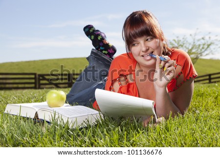 College student is studying outside in the backyard