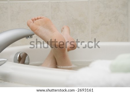 Girl's feet sticking out from bath tub