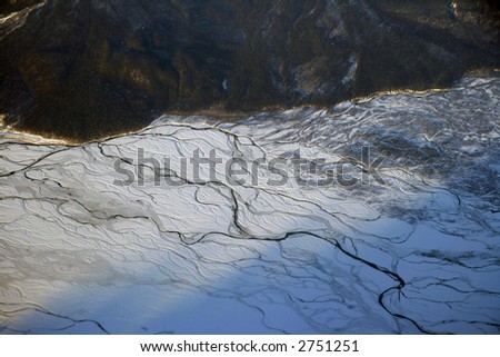 Aerial view of mountains and frozen rivers of Alaska