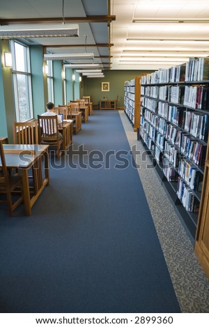 Study area in the library with a person working on laptop computer