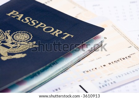 Travel documents: passport and airline tickets with calendar in the background
