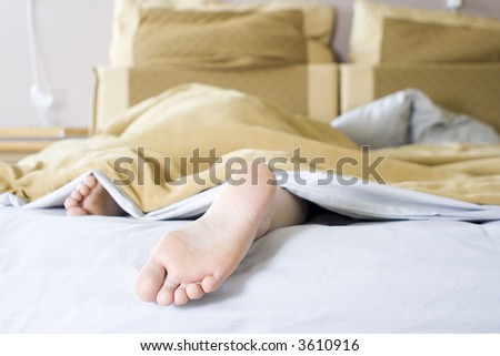 Girl lazying in bed on a Sunday morning