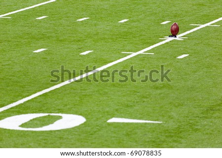 Football on a kicking stand in the  football field
