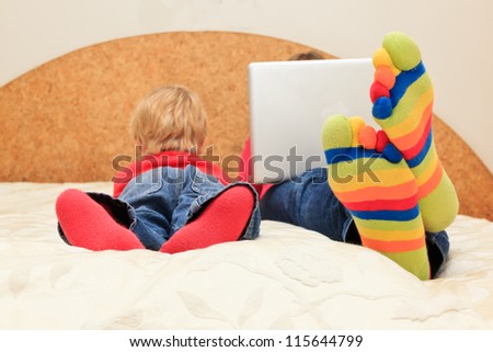 family with computer and touch pad at home