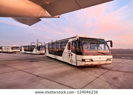 DUBAI, UAE - DECEMBER 26: Buses carrying passengers at Dubai Airport on December 26, 2012 in Dubai, UAE. Dubai airport is major aviation hub in the Middle East.