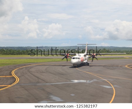 BALI - JANUARY 04: Wings Air plane landed at Denpasar International Airport on January 4, 2013 in Bali, Indonesia. Airport capacity is growing, planned to reach maximum of 20 mln travelers by 2017.