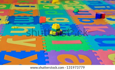 baby toys on puzzlel floor cover, playroom