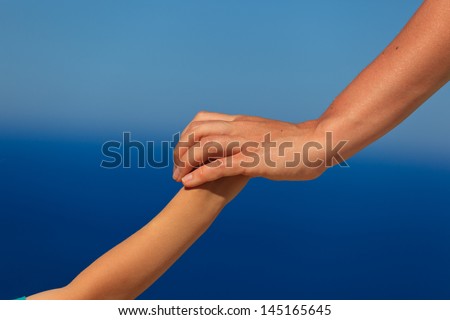 mother and son holding hands on vacation