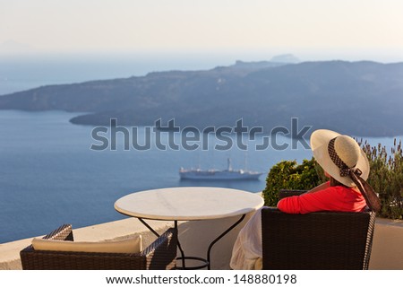 young woman enjoying view of Santorini, Greece
