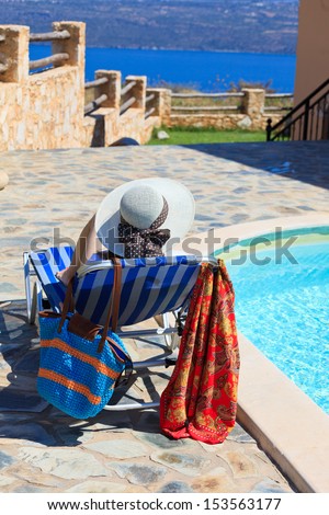 happy woman on sea vacation by the pool