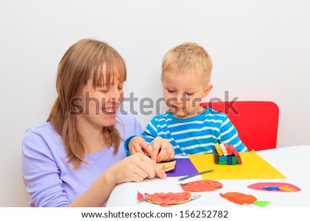 mother and son playing with plasticine, early learning and daycare concept