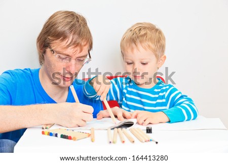 father and son drawing together, early education