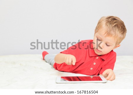 little boy with touch pad, early learning