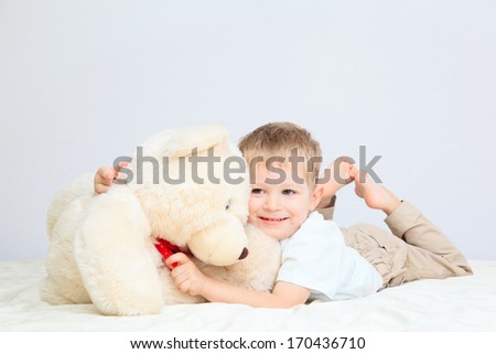 Portrait of little boy with teddy bear at home, home comfort and leisure