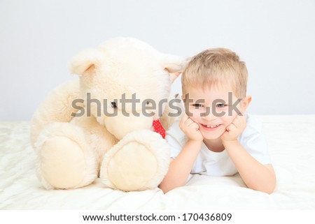 Portrait of little boy with teddy bear at home, home comfort and leisure