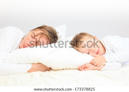 father and son sleep in bed, family leisure