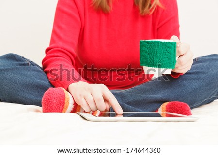 young woman with cup of coffee and tablet at home, home comfort