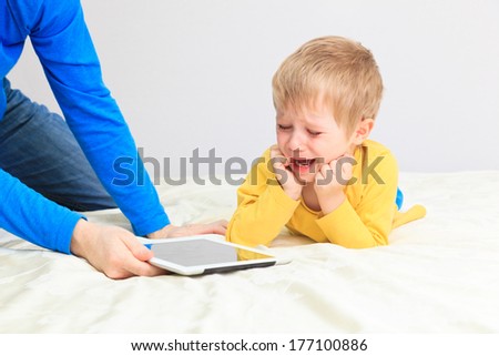 computer addiction, parent taking out touch pad from child