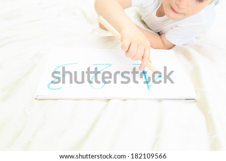 hands of little boy writing numbers, early education