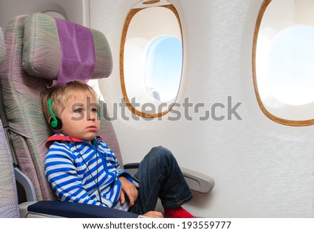 little boy watching tv in flight, travel concept
