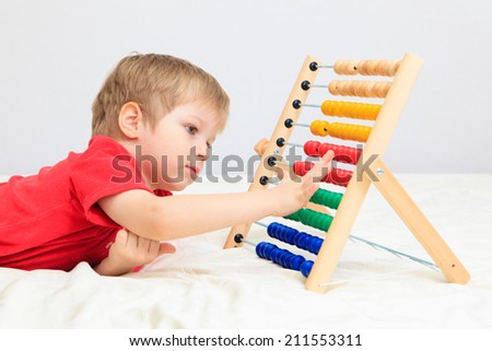 little boy playing with abacus, early learning