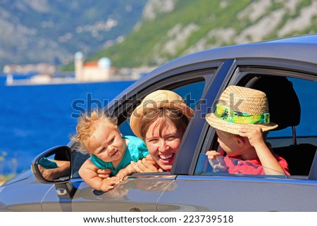 mother with kids travel by car on sea vacation