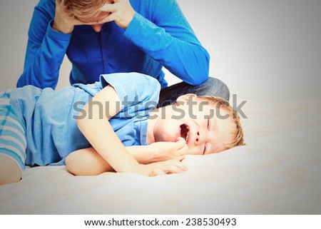 crying child, tired father- difficult parenting