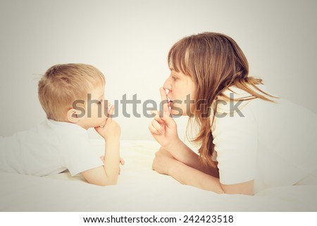 mother and little son sharing secret