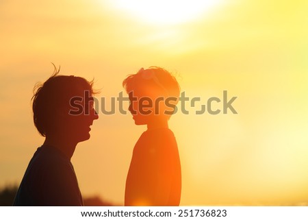 father and son at sunset beach, family concept